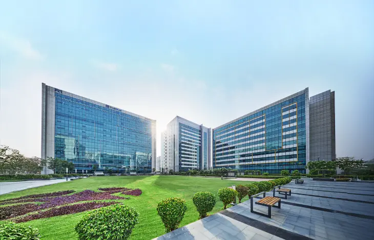 Candor TechSpace, Sector 48, Gurugram, featuring modern glass office buildings and a landscaped green area.