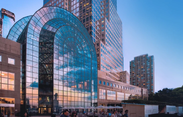 The Winter Garden at Brookfield Place, New York, featuring a grand glass atrium with reflections of the city skyline