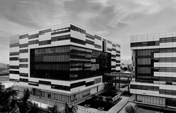 Black and white image of Candor TechSpace, Newtown, Kolkata, showcasing modern office buildings with geometric glass facades.