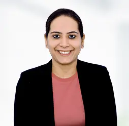 Ruhi Goswami, Senior Vice President & General Counsel, smiling confidently in a black blazer with a professional and approachable demeanor.