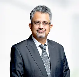 Subrata Ghosh, Senior Vice President - Regional Head, posing confidently in a formal suit, representing leadership and regional expertise within the company.