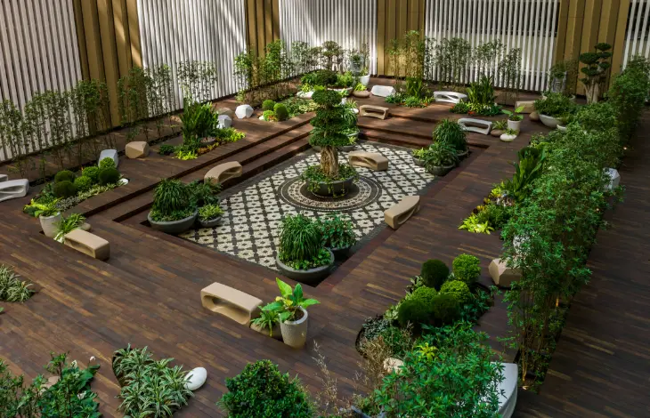 A beautifully designed garden space with plants and seating arrangements at Candor TechSpace, Sector 135, Noida