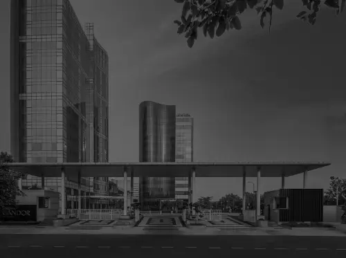 Black and white image of Candor TechSpace, Sector 62, Noida, featuring modern glass office buildings and a structured entrance gate.
